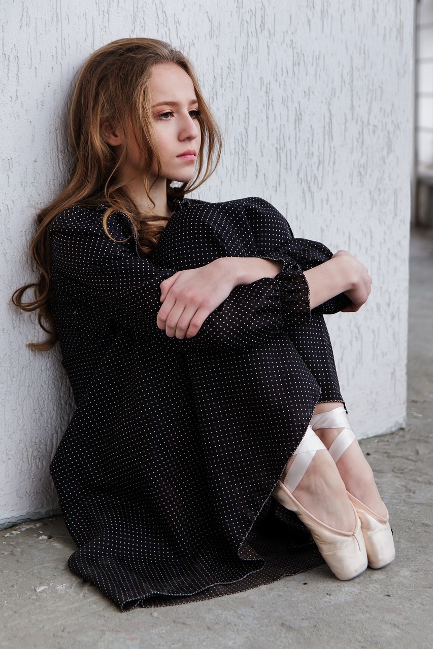 Sad Woman sitting against wall