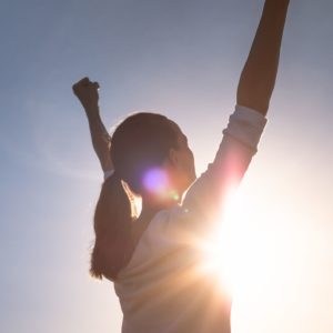 women raised hands to show her success