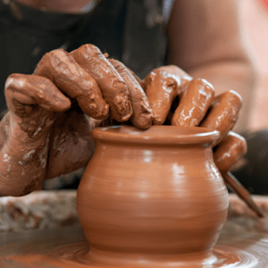 A person making a clay pot. Boost your transformation day