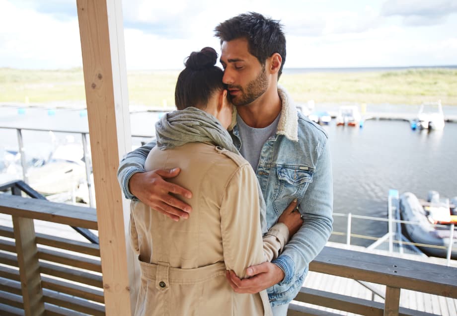 Couple embracing on a balcony, symbolizing emotional connection and healing in relationships
